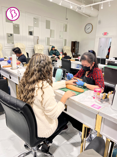 Client choosing from a variety of nail treatments at Bnails