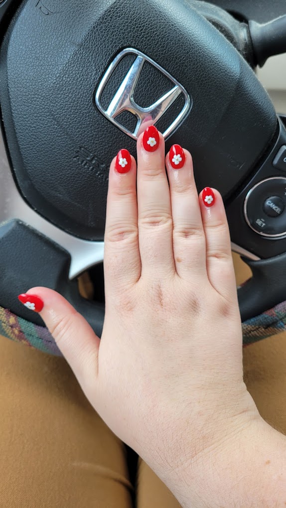 Floral nail designs with hand-painted flowers and daisy accents at Bnails
