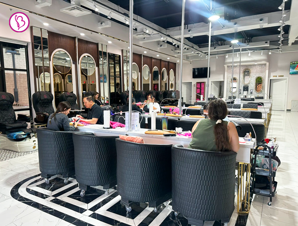 Smiling client receiving nail service at Bnails Lubbock, a joyful and professional nail salon in the U.S.