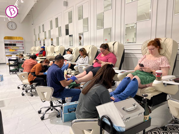 Smiling customer after receiving nail services at walk-in salon